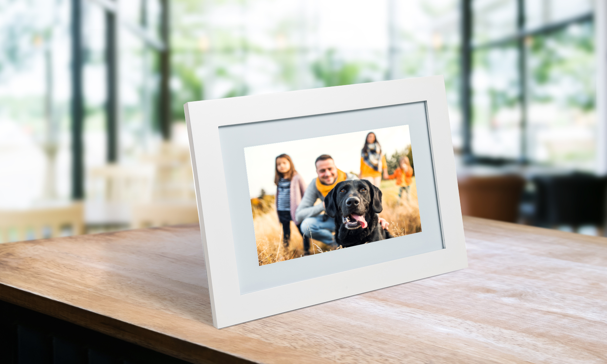 A digital frame with a white frame with a picture of a family and a dog